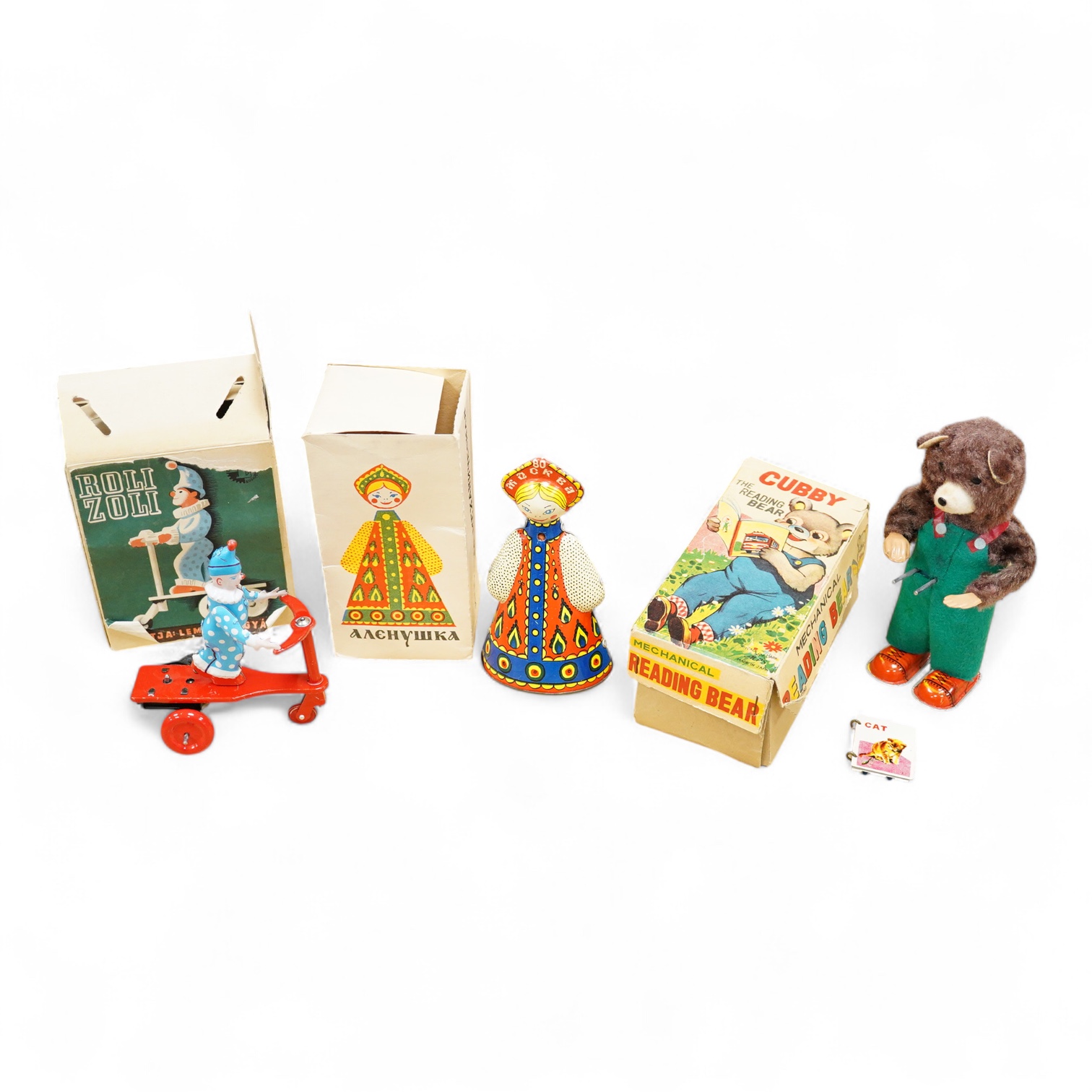 Three boxed clockwork tinplate toys - a 1960s Japanese Cubby the Reading Bear, by Alps (Japan), 17cm high, a USSR doll, and a later ‘Roli Zoli’ clown on a scooter (3)